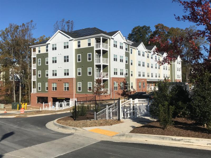 White aluminum railing around apartment building perimeter