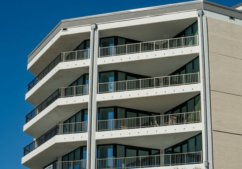 Aluminum balcony railing with continuous top rail design on multi-story residential building