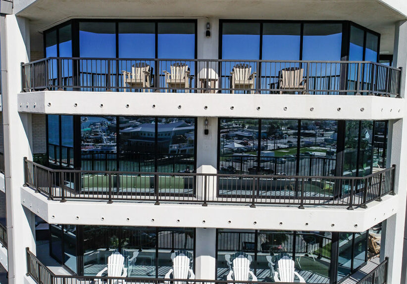 Powder-coated aluminum balcony railing with post-to-post design on waterfront high-rise